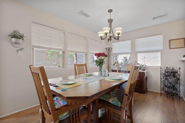 10027 Vista Cantera Ln NW, Albuquerque, NM 87114 - dining area with a chandelier and light wood-style floors