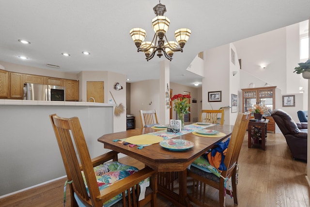 10027 Vista Cantera Ln NW, Albuquerque, NM 87114 - dining area with recessed lighting, wood finished floors, and a chandelier