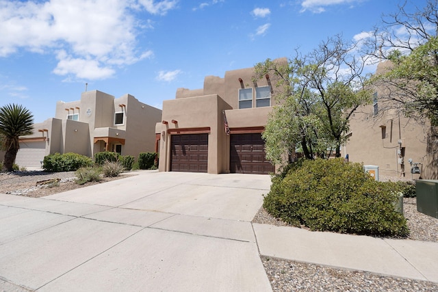 10027 Vista Cantera Ln NW, Albuquerque, NM 87114 - adobe home with concrete driveway, stucco siding, and an attached garage
