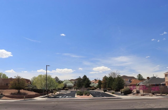 10027 Vista Cantera Ln NW, Albuquerque, NM 87114 - view of asphalt road with sidewalks, a residential view, and curbs