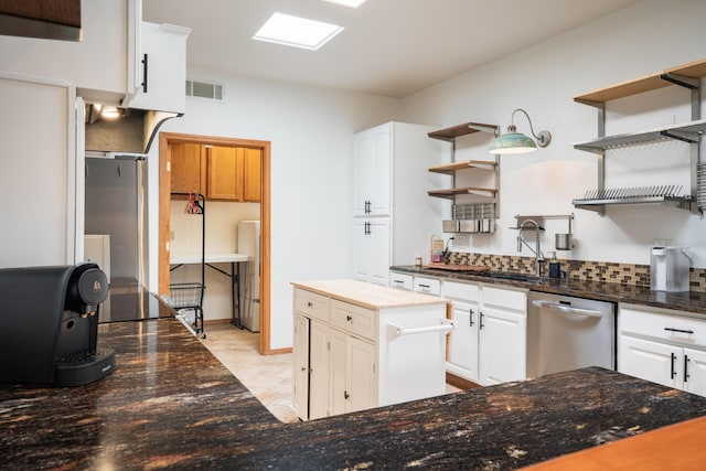 5 Ocotillo Way, Placitas, NM 87043 - kitchen featuring open shelves, stainless steel dishwasher, white cabinetry, and dark stone countertops