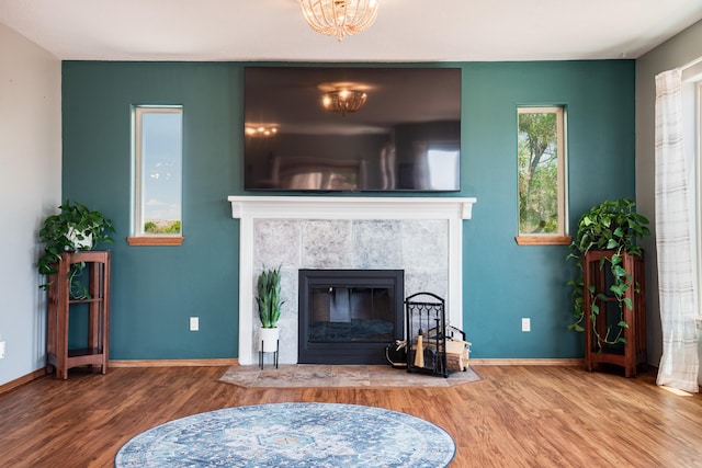5 Ocotillo Way, Placitas, NM 87043 - living area featuring wood finished floors, a tiled fireplace, and a chandelier