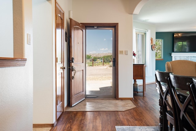 5 Ocotillo Way, Placitas, NM 87043 - entryway with wood finished floors, arched walkways, and a fireplace
