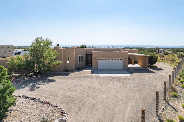5 Ocotillo Way, Placitas, NM 87043 - southwest-style home with concrete driveway, an attached garage, and stucco siding