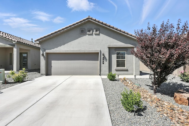 583 Turmalina Dr SE, Rio Rancho, NM 87124 - view of front facade featuring an attached garage, stucco siding, driveway, and a tile roof