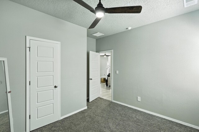 583 Turmalina Dr SE, Rio Rancho, NM 87124 - unfurnished bedroom featuring dark colored carpet, a textured ceiling, and a ceiling fan