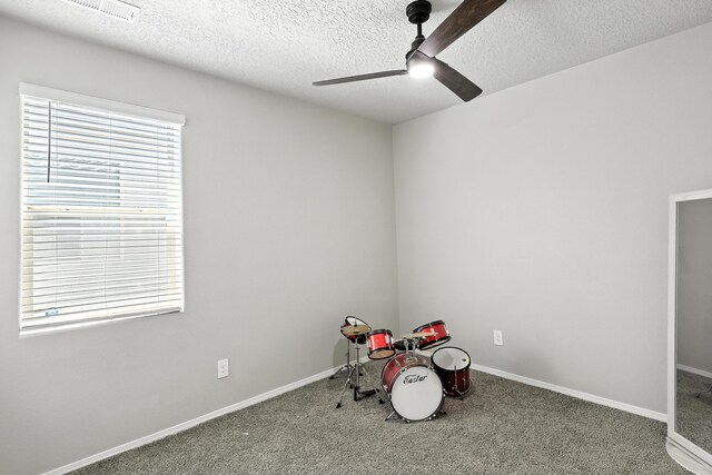 583 Turmalina Dr SE, Rio Rancho, NM 87124 - playroom featuring ceiling fan, carpet floors, and a textured ceiling