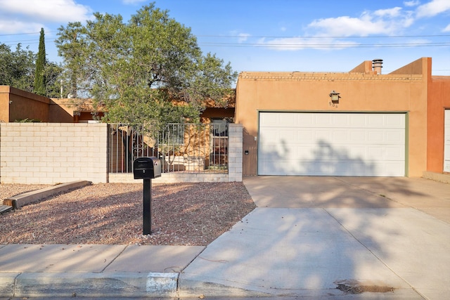 504 Ortiz Dr NE, Albuquerque, NM 87108 - southwest-style home featuring driveway, a gate, a garage, and stucco siding