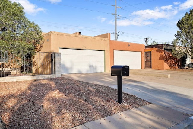504 Ortiz Dr NE, Albuquerque, NM 87108 - southwest-style home featuring stucco siding and driveway