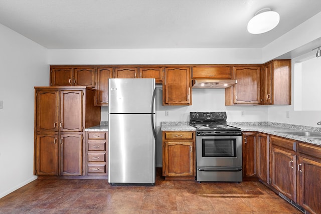504 Ortiz Dr NE, Albuquerque, NM 87108 - kitchen featuring appliances with stainless steel finishes, under cabinet range hood, light countertops, and brown cabinetry