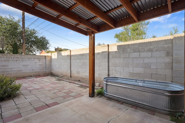 504 Ortiz Dr NE, Albuquerque, NM 87108 - fenced backyard with a hot tub and a patio