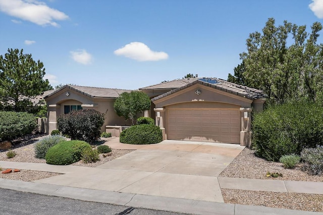 13100 Desert Moon Pl NE, Albuquerque, NM 87111 - view of front of house featuring stucco siding, a tiled roof, concrete driveway, and an attached garage