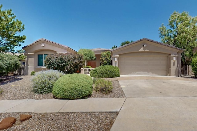 13100 Desert Moon Pl NE, Albuquerque, NM 87111 - mediterranean / spanish-style house featuring stucco siding, concrete driveway, a garage, and a tile roof