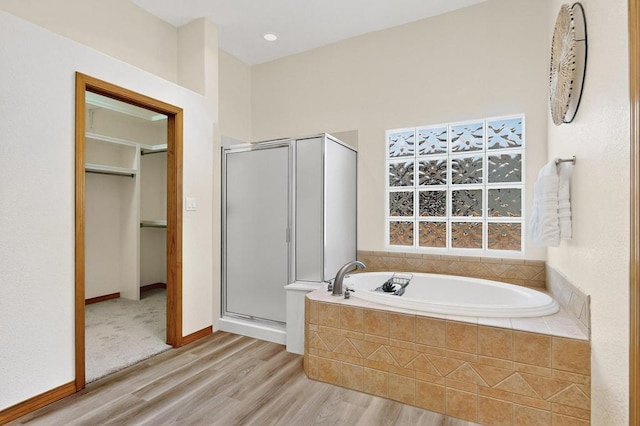 13100 Desert Moon Pl NE, Albuquerque, NM 87111 - full bathroom with a stall shower, wood finished floors, a garden tub, and a walk in closet