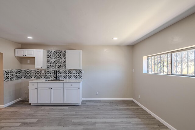 245 Chama St NE, Albuquerque, NM 87108 - kitchen featuring white cabinetry, recessed lighting, light wood-style floors, decorative backsplash, and light countertops