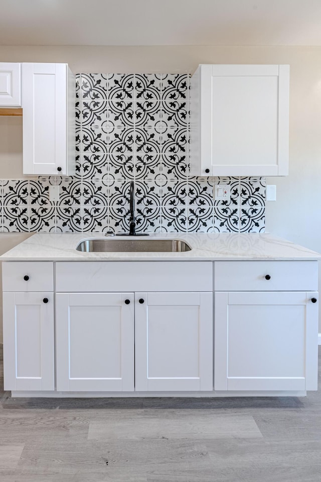 245 Chama St NE, Albuquerque, NM 87108 - kitchen with light wood-style flooring, white cabinets, and light countertops