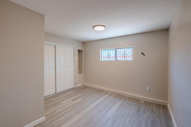 245 Chama St NE, Albuquerque, NM 87108 - unfurnished bedroom with light wood finished floors and a closet