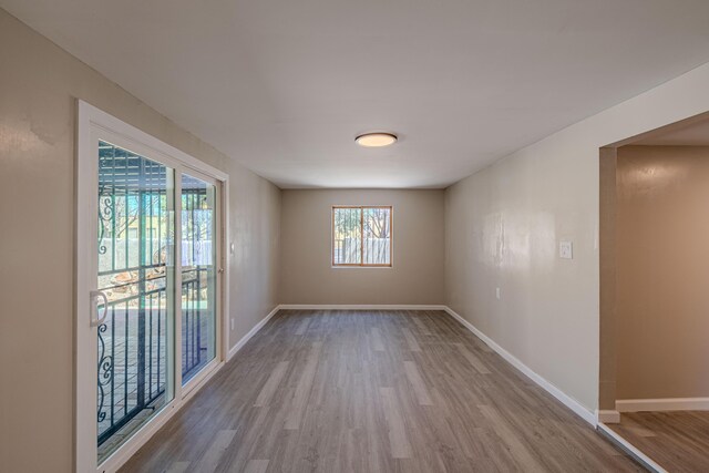 245 Chama St NE, Albuquerque, NM 87108 - spare room featuring wood finished floors and baseboards