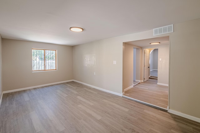 245 Chama St NE, Albuquerque, NM 87108 - empty room with arched walkways and light wood finished floors