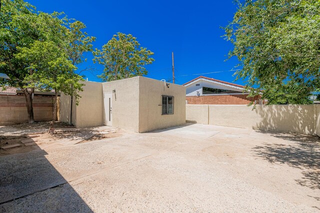 245 Chama St NE, Albuquerque, NM 87108 - rear view of house with stucco siding and a patio area