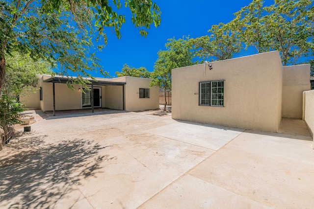 245 Chama St NE, Albuquerque, NM 87108 - back of house featuring stucco siding and a patio