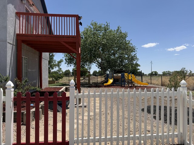 4 Los Chavez Park Rd, Belen, NM 87002 - view of yard featuring a playground and a balcony