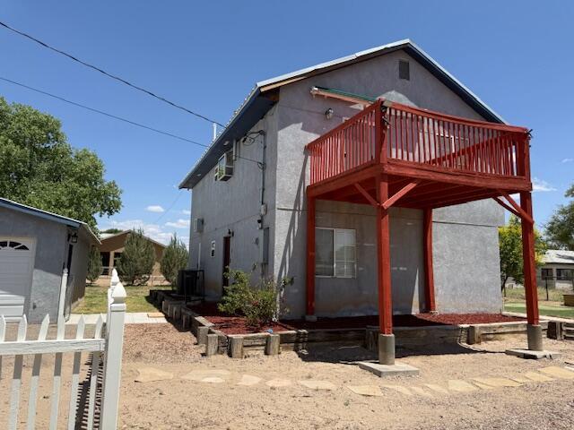 4 Los Chavez Park Rd, Belen, NM 87002 - back of house featuring a wooden deck