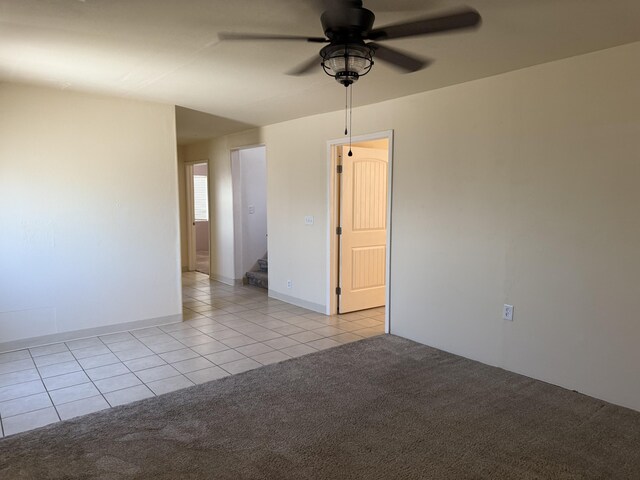 4 Los Chavez Park Rd, Belen, NM 87002 - empty room featuring light tile patterned floors, a ceiling fan, light colored carpet, and stairway