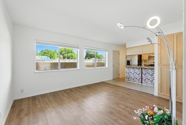 4200 Montgomery Blvd NE Unit 109, Albuquerque, NM 87109 - unfurnished living room featuring light wood-type flooring and a sink