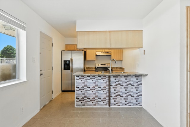 4200 Montgomery Blvd NE Unit 109, Albuquerque, NM 87109 - kitchen featuring stainless steel appliances, light brown cabinets, a peninsula, under cabinet range hood, and light stone counters