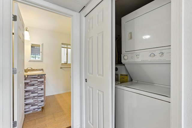 4200 Montgomery Blvd NE Unit 109, Albuquerque, NM 87109 - laundry area with stacked washer / dryer and light tile patterned floors
