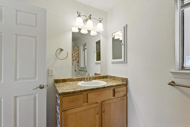 4200 Montgomery Blvd NE Unit 109, Albuquerque, NM 87109 - full bathroom featuring vanity and a textured wall