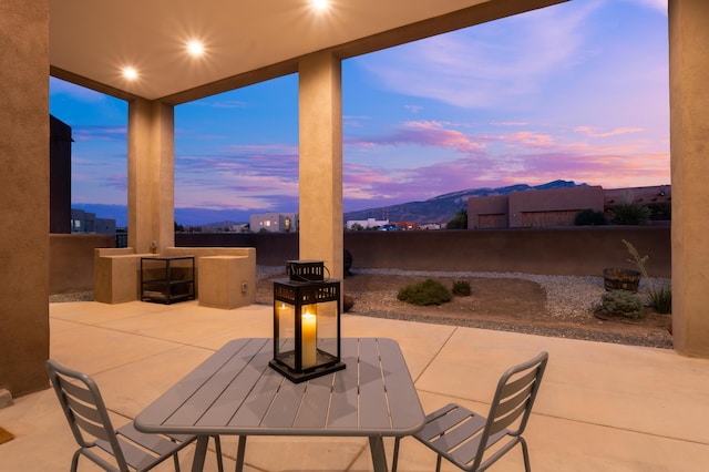24 Norte Trl, Placitas, NM 87043 - patio terrace at dusk featuring a patio, a fenced backyard, and a mountain view