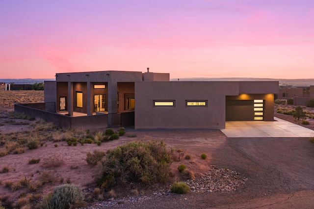24 Norte Trl, Placitas, NM 87043 - pueblo-style house with driveway, an attached garage, and stucco siding