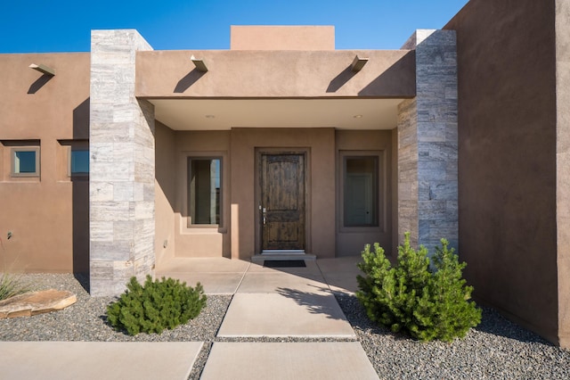 24 Norte Trl, Placitas, NM 87043 - doorway to property with stone siding and stucco siding