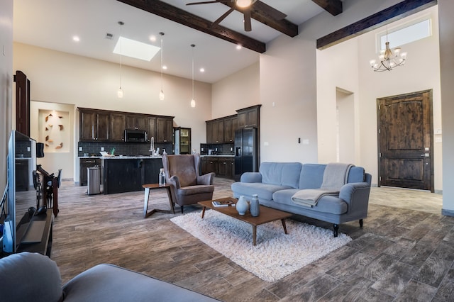24 Norte Trl, Placitas, NM 87043 - living area with a towering ceiling, ceiling fan, dark wood finished floors, beamed ceiling, and a chandelier