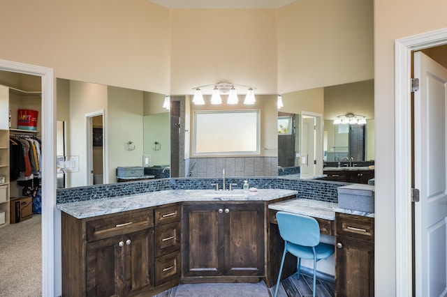 24 Norte Trl, Placitas, NM 87043 - full bathroom featuring vanity, a spacious closet, and a towering ceiling