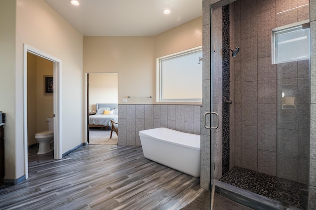 24 Norte Trl, Placitas, NM 87043 - ensuite bathroom featuring a freestanding bath, plenty of natural light, a stall shower, wood finished floors, and recessed lighting