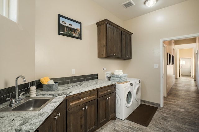 24 Norte Trl, Placitas, NM 87043 - washroom featuring cabinet space, washing machine and dryer, and wood finished floors
