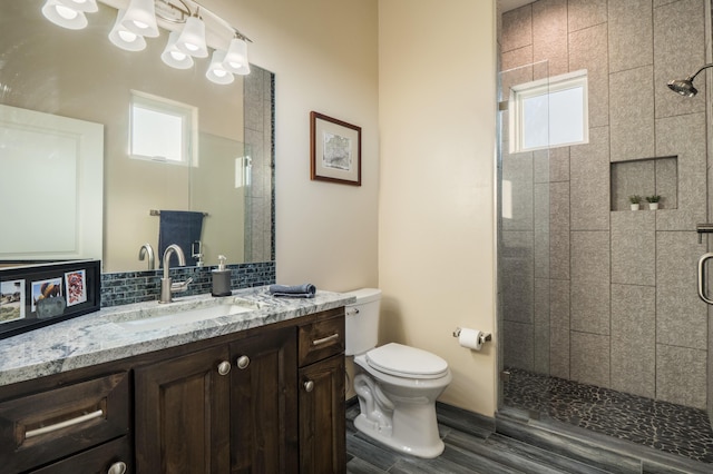 24 Norte Trl, Placitas, NM 87043 - bathroom with a stall shower, vanity, tasteful backsplash, and wood finished floors