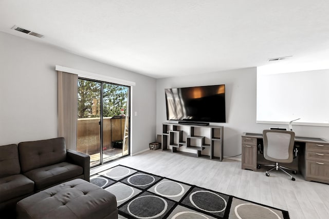 4801 Irving Blvd NW Unit 304, Albuquerque, NM 87114 - living room featuring light wood finished floors and a desk