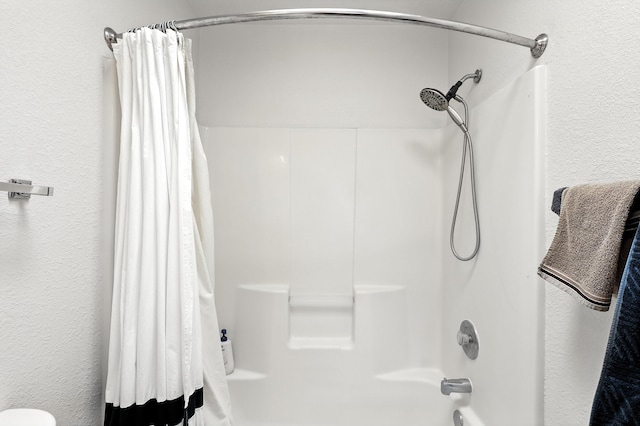 4801 Irving Blvd NW Unit 304, Albuquerque, NM 87114 - bathroom featuring shower / tub combo with curtain and a textured wall