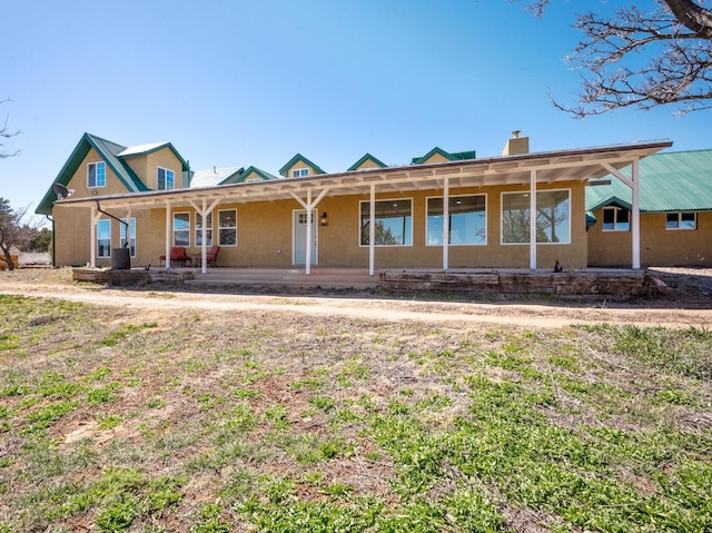 19 Bobcat Hill Rd, Sandia Park, NM 87047 - view of front of property with a chimney and a porch