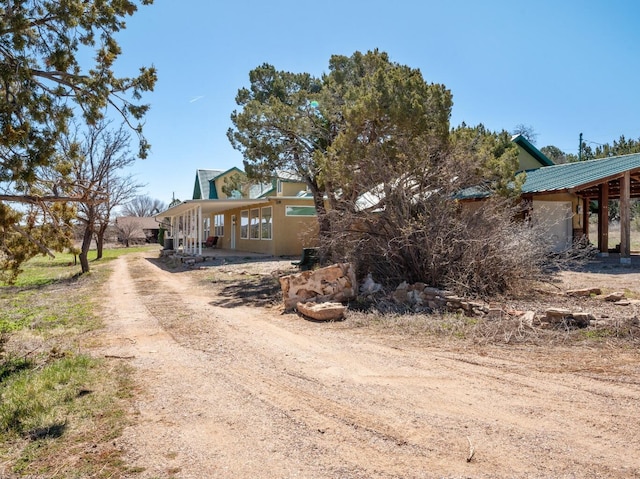 19 Bobcat Hill Rd, Sandia Park, NM 87047 - view of front of home featuring driveway and a metal roof
