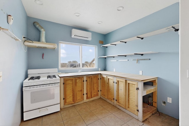 228 18th St SW, Rio Rancho, NM 87124 - kitchen with open shelves, white range with gas cooktop, an AC wall unit, range hood, and light tile patterned floors