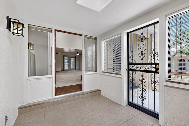 12800 Comanche Rd NE Unit 23, Albuquerque, NM 87111 - tiled entryway featuring a textured wall, a ceiling fan, and healthy amount of natural light