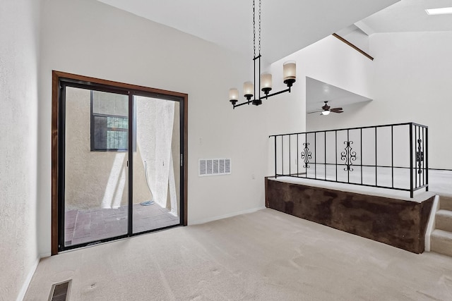 12800 Comanche Rd NE Unit 23, Albuquerque, NM 87111 - unfurnished dining area with carpet floors, a chandelier, ceiling fan, vaulted ceiling, and stairway