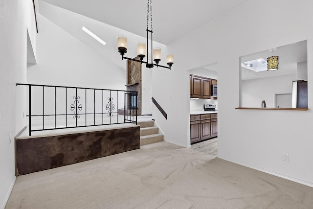 12800 Comanche Rd NE Unit 23, Albuquerque, NM 87111 - stairway with high vaulted ceiling, carpet flooring, and a chandelier