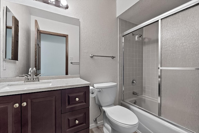 12800 Comanche Rd NE Unit 23, Albuquerque, NM 87111 - bathroom featuring a textured wall, vanity, and combined bath / shower with glass door