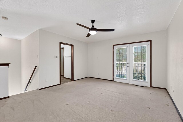 12800 Comanche Rd NE Unit 23, Albuquerque, NM 87111 - empty room with french doors, carpet flooring, a textured ceiling, and a ceiling fan